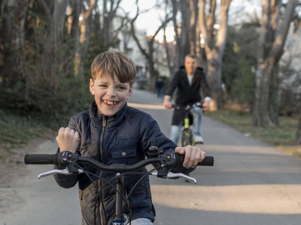 A boy's joyful expression as he rides his bike with confidence