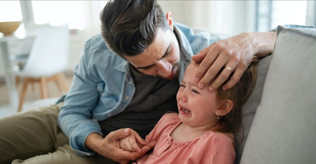 when your child says hurtful things to you - dad trying to calm his crying little girl