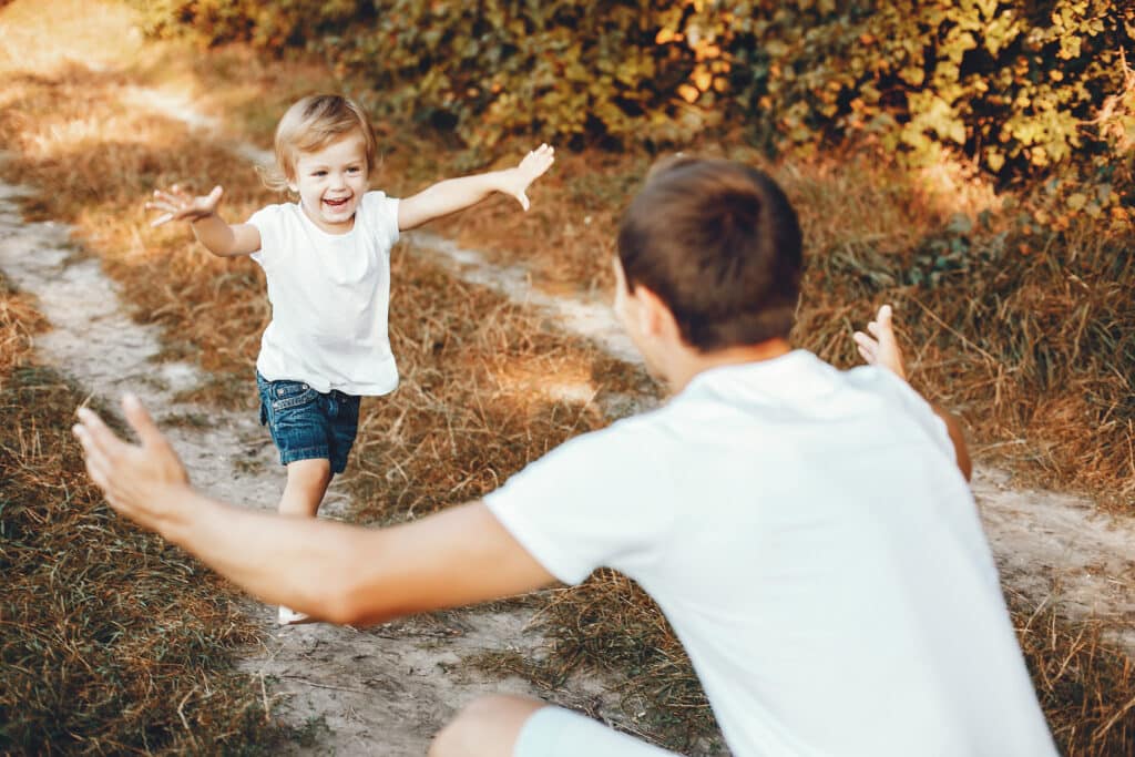little girl running towards her dad