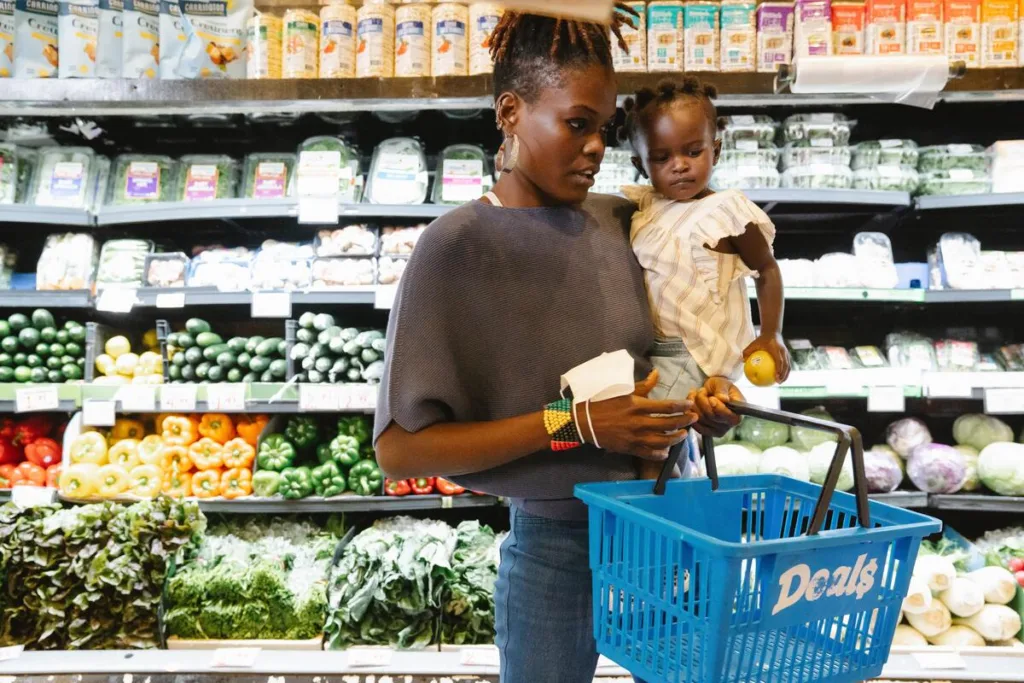 chores for kids - A mother and daughter at the vegetable isle grocery shopping

