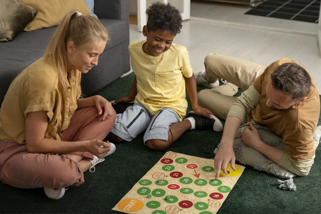Family playing a board game on the carpet