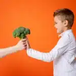 how to get kids to eat veggies - little boy refusing broccoli
