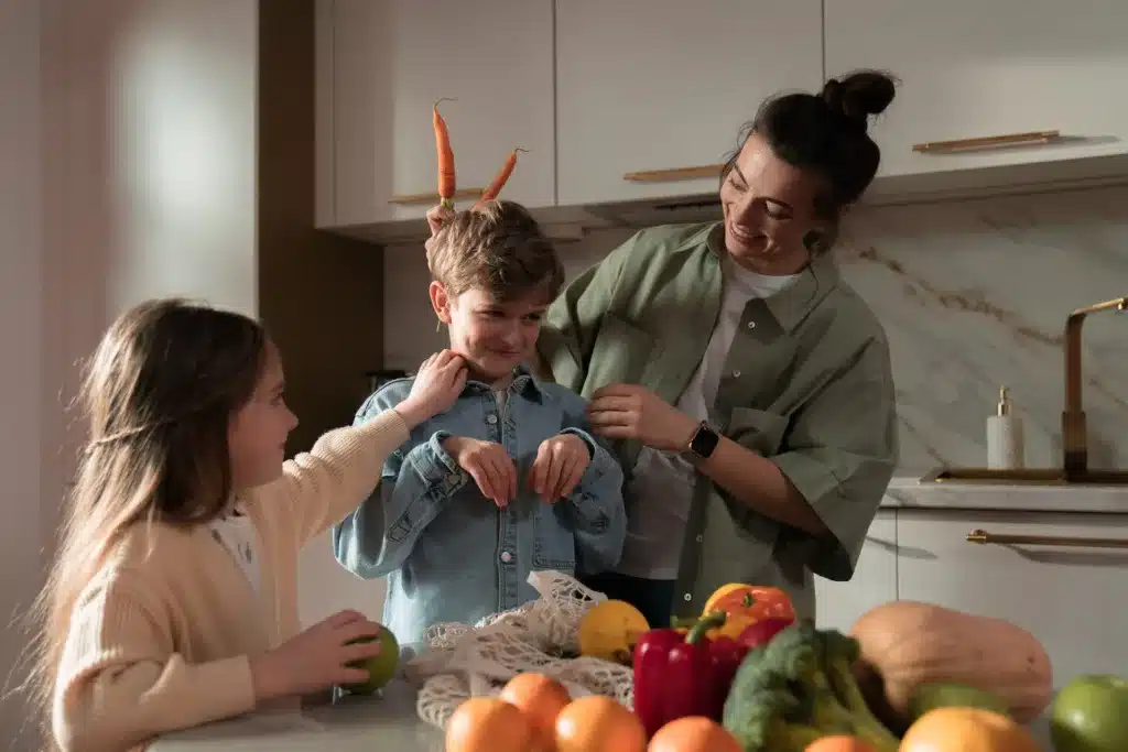 Joyful mom and kids engaging in playful kitchen activities, exploring the vibrant colors and textures of fresh vegetables together