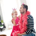 Father and daughter playing dressed up as princesses