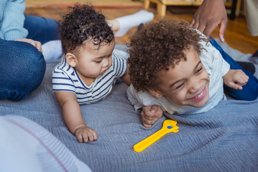 two brothers playing on the floor