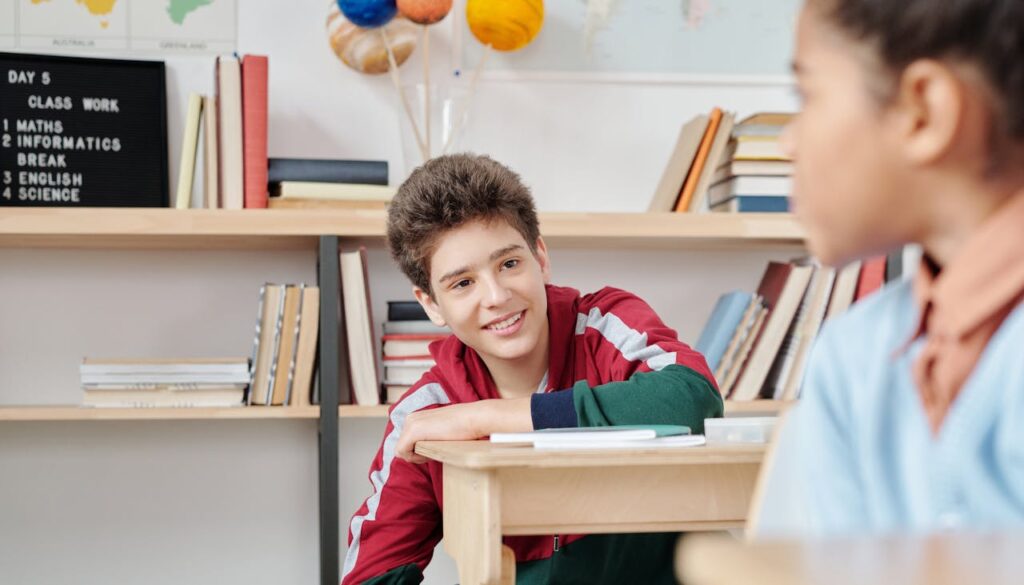 Boy laughing at his desk in the classroom