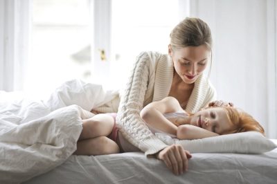 morning routine for kids: mom waking up daughter