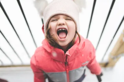 anger management for kids - Little girl in winter clothes yelling