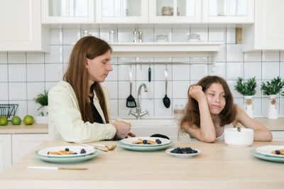 Things a step-parent should never do: mom talking with daughter at breakfast