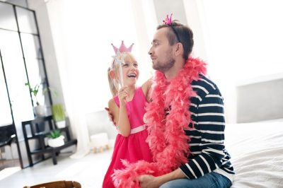 Father and daughter playing dressed up as princesses